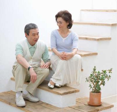 Older couple on stairs considering a residential elevator